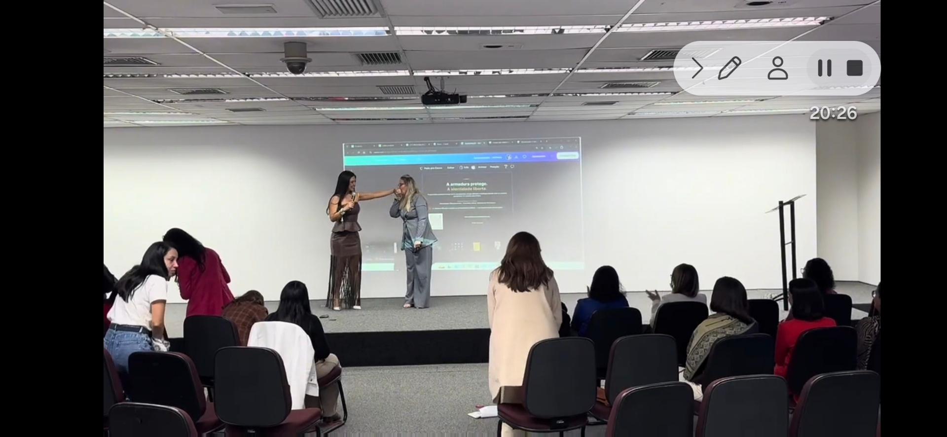 Adriana Carvalho conduzindo momento com participante no palco do Diamond Women Curitiba diante da plateia